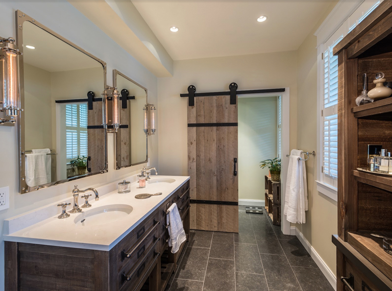 The Interior To The New Master Bath Is A Study In Textural And Tonal Contrasts. Porcelain Tile Flooring. Mirrors Framed In Polished Nickel.
Plantation Shutters. The Door To The Commode Is Reclaimed Barn Door Mounted On Antique Rollers . . .